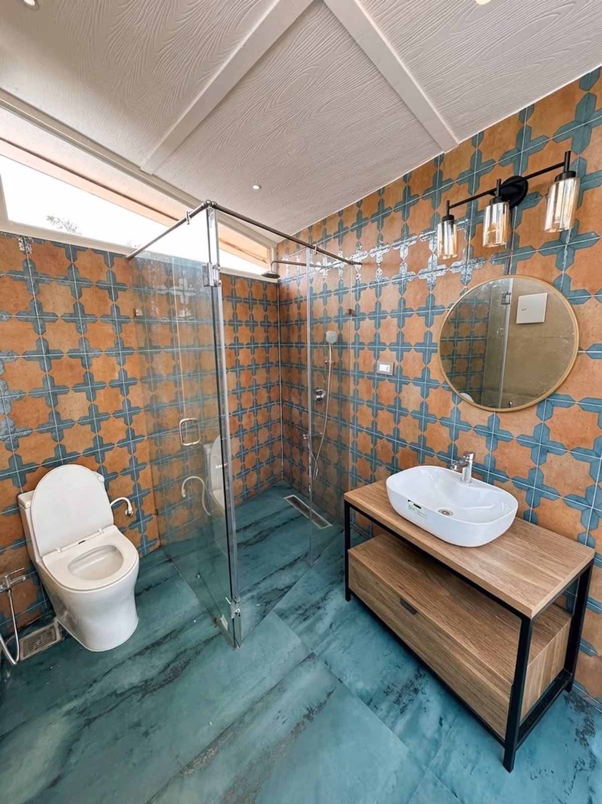 Full dome bathroom layout with glass shower, terracotta and teal tiled walls