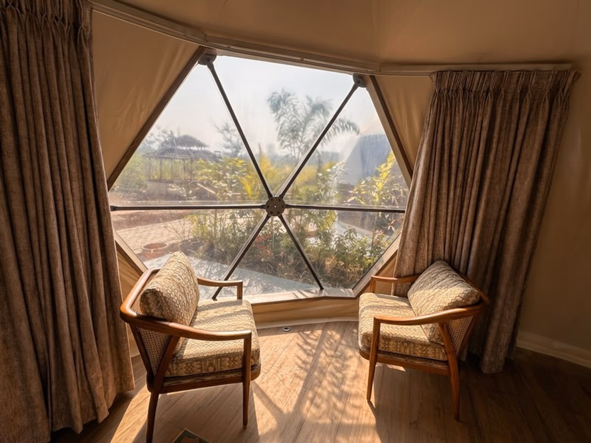 Garden Glade Getaways - two armchairs facing hexagonal window with garden view