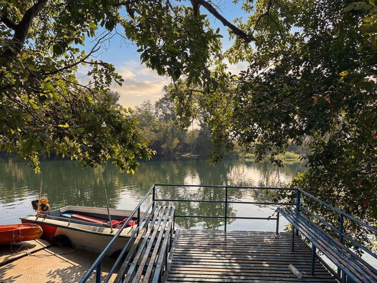 Dock and jetty on the Pavana river framed by overhanging trees