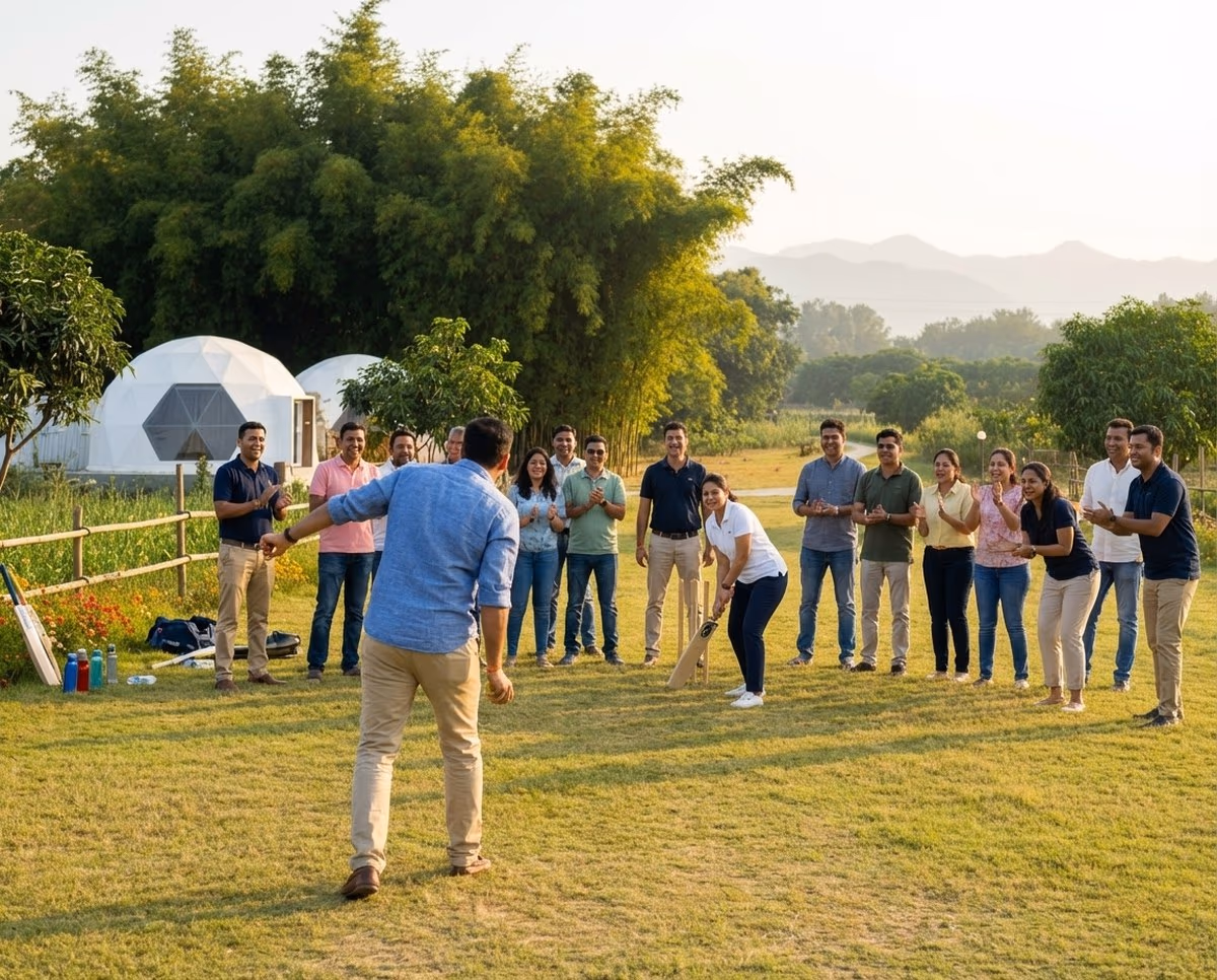 Corporate team playing cricket on the resort lawn at golden hour