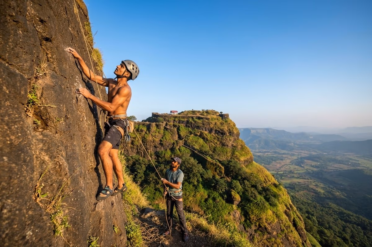 Rock climbing on natural formations at Tikona fort near The Glen Woods Resort