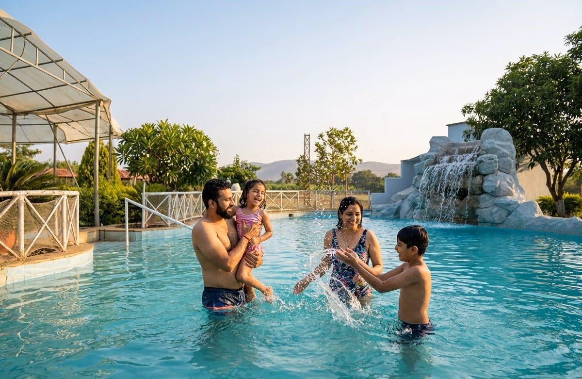 Family enjoying the resort swimming pool with rock waterfall