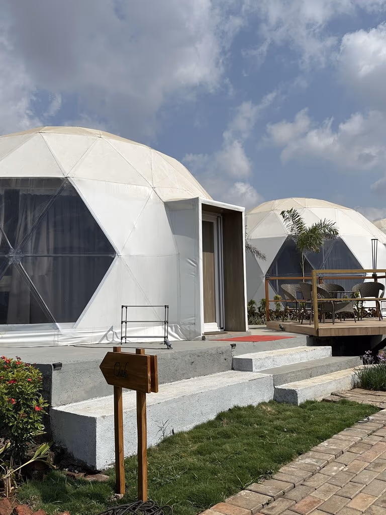 Geodesic dome glamping accommodations with glass fronts and private decks at The Glen Woods Resort